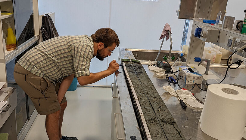 Fig. 4: Rafal Nawrot inspects an opened sediment core. 
