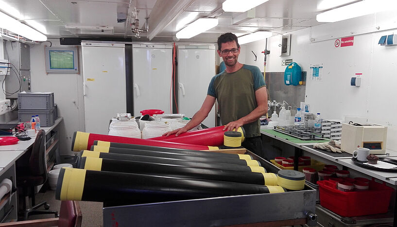 Fig. 2: Martin Zuschin with drill cores on a research vessel in the Adriatic Sea. 
